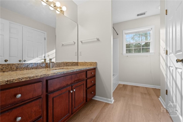 800 N Taylor Ct, Statesboro, GA 30461 - full bath featuring wood finished floors, vanity, washtub / shower combination, and baseboards