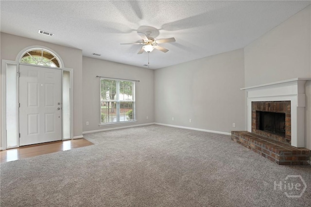 301 Morgan Pines Dr, Pooler, GA 31322 - unfurnished living room with carpet, ceiling fan, a fireplace, baseboards, and a textured ceiling