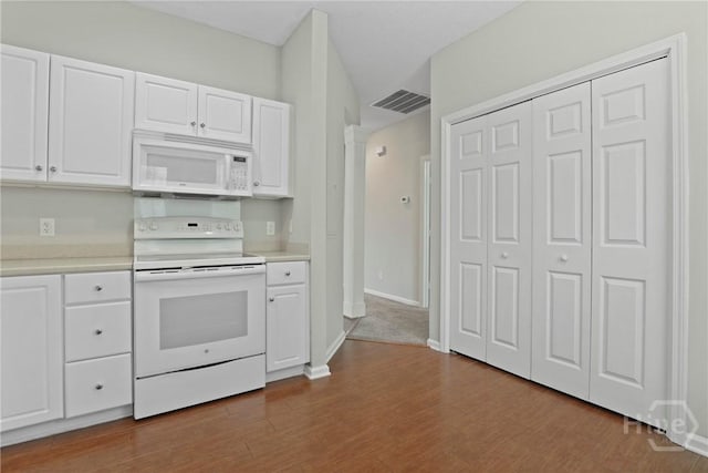 301 Morgan Pines Dr, Pooler, GA 31322 - kitchen with white appliances, white cabinets, light countertops, dark wood-type flooring, and decorative columns