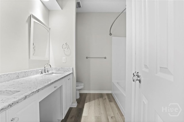 301 Morgan Pines Dr, Pooler, GA 31322 - full bathroom featuring wood finished floors, double vanity, shower / tub combination, toilet, and baseboards