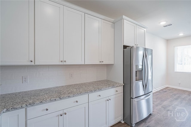 147 Congo Ct, Pooler, GA 31322 - kitchen with stainless steel fridge with ice dispenser, white cabinetry, light wood finished floors, tasteful backsplash, and baseboards