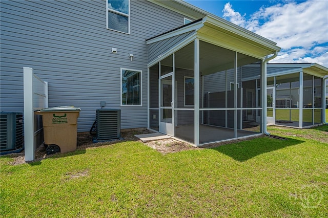 147 Congo Ct, Pooler, GA 31322 - back of property with a sunroom, central air condition unit, and a lawn