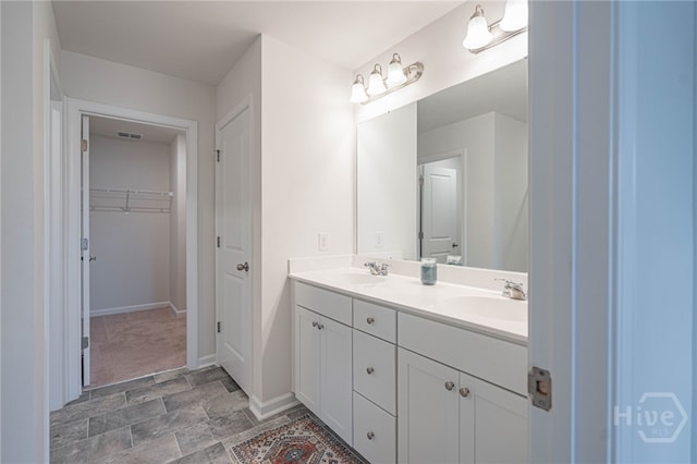 147 Congo Ct, Pooler, GA 31322 - bathroom with double vanity, stone finish floors, baseboards, and a spacious closet