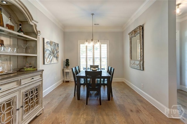 23 Golf Dr, Pooler, GA 31322 - dining area with a chandelier, baseboards, ornamental molding, and light wood-type flooring