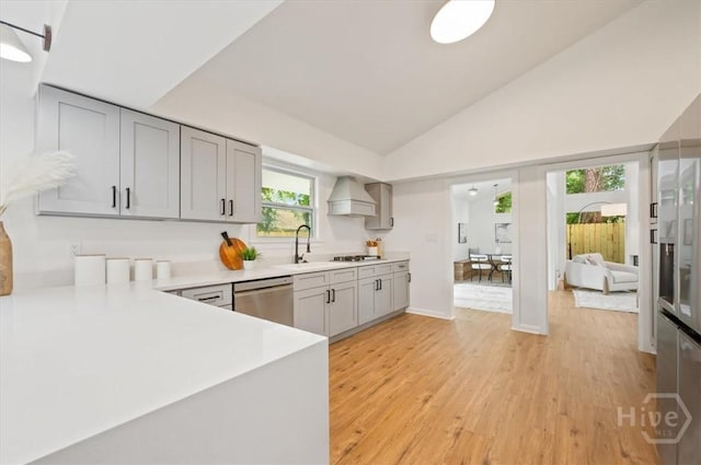 4750 Sylvan Dr, Savannah, GA 31405 - kitchen featuring stainless steel dishwasher, light countertops, light wood finished floors, gray cabinets, and a sink