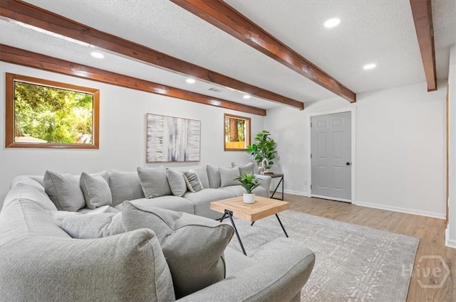 4750 Sylvan Dr, Savannah, GA 31405 - living room with recessed lighting, beam ceiling, light wood-style floors, baseboards, and a textured ceiling