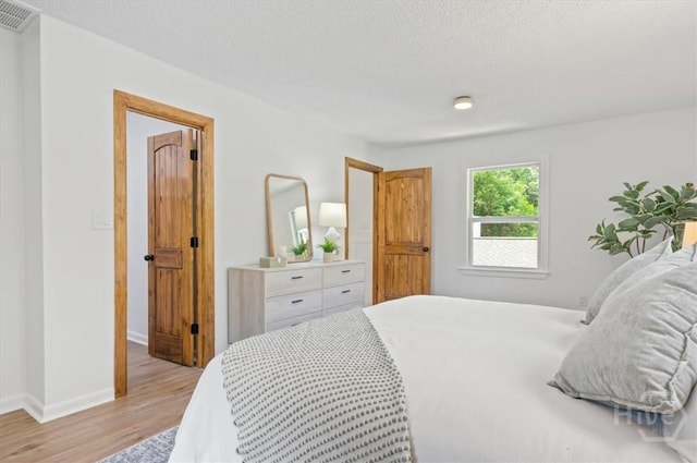 4750 Sylvan Dr, Savannah, GA 31405 - bedroom featuring light wood finished floors, baseboards, and a textured ceiling