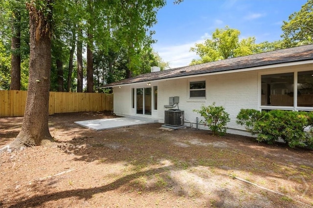 4750 Sylvan Dr, Savannah, GA 31405 - rear view of property with brick siding, central AC, and a patio area