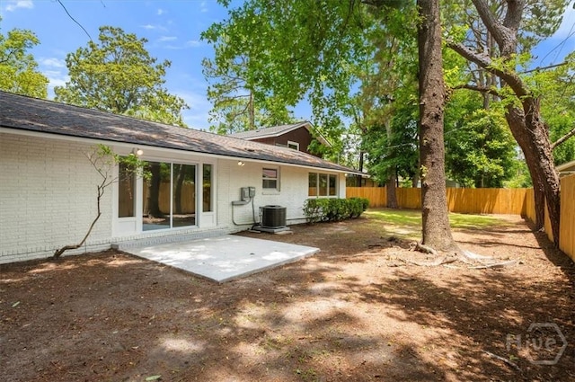 4750 Sylvan Dr, Savannah, GA 31405 - rear view of house with brick siding, a fenced backyard, a patio, and central AC