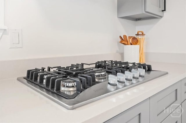 4750 Sylvan Dr, Savannah, GA 31405 - kitchen view of stainless steel gas cooktop, light countertops, and gray cabinetry