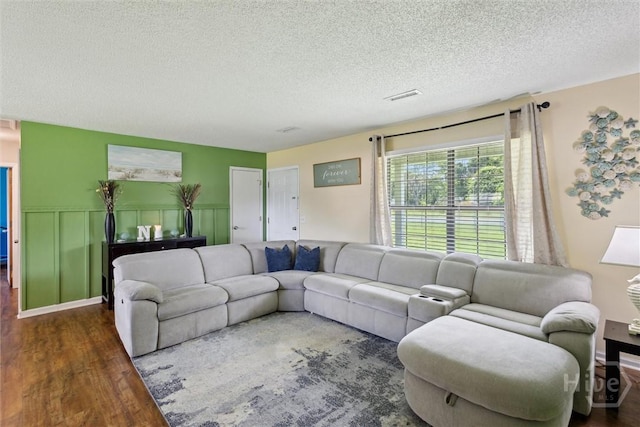 151 Ogeechee Ave, Bloomingdale, GA 31302 - living room with wood finished floors, a textured ceiling, and wainscoting