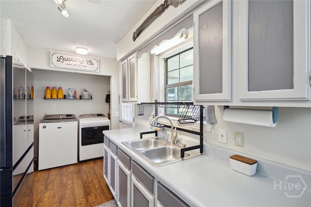 151 Ogeechee Ave, Bloomingdale, GA 31302 - kitchen featuring washing machine and clothes dryer, a sink, a textured ceiling, light countertops, and dark wood-style floors