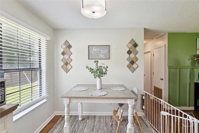 151 Ogeechee Ave, Bloomingdale, GA 31302 - dining room featuring a textured ceiling, wood finished floors, and baseboards