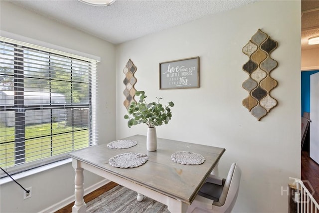 151 Ogeechee Ave, Bloomingdale, GA 31302 - dining room with a textured ceiling, wood finished floors, and baseboards