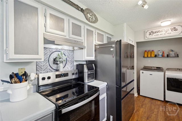 151 Ogeechee Ave, Bloomingdale, GA 31302 - kitchen with washer and dryer, stainless steel electric range oven, under cabinet range hood, a textured ceiling, and wood finished floors