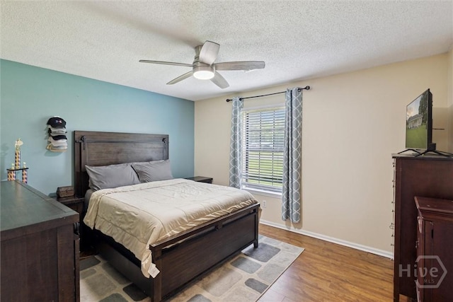 151 Ogeechee Ave, Bloomingdale, GA 31302 - bedroom with wood finished floors, baseboards, a textured ceiling, and ceiling fan