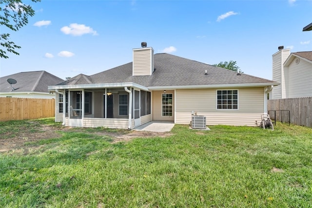 210 Pebblestone Dr, Bloomingdale, GA 31302 - back of property with a sunroom, a chimney, a shingled roof, and central AC