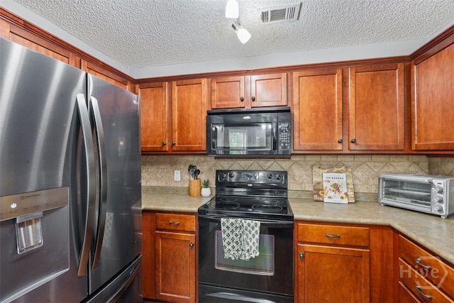 210 Pebblestone Dr, Bloomingdale, GA 31302 - kitchen featuring black appliances, light countertops, decorative backsplash, and a textured ceiling