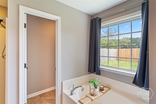 210 Pebblestone Dr, Bloomingdale, GA 31302 - bathroom featuring a bath and a textured ceiling