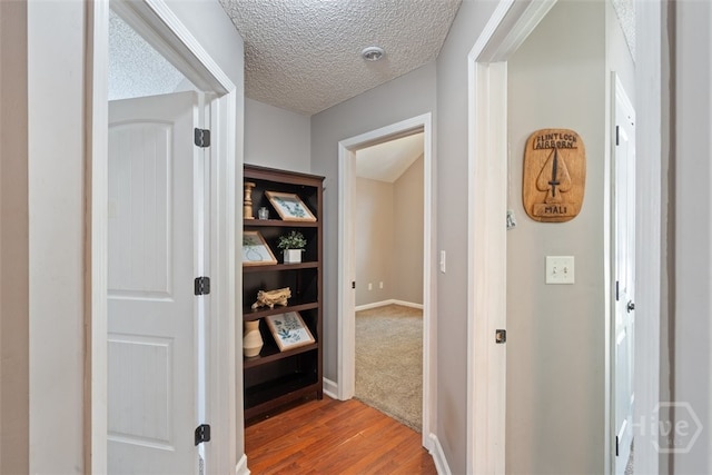 210 Pebblestone Dr, Bloomingdale, GA 31302 - hall featuring wood finished floors, a textured ceiling, and baseboards