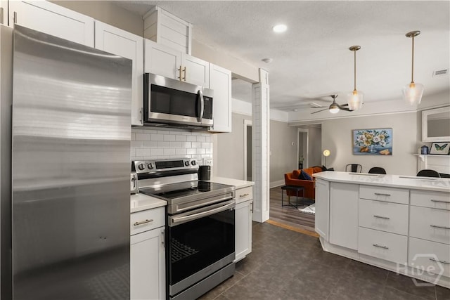 2301 Alaska St, Savannah, GA 31404 - kitchen featuring appliances with stainless steel finishes, a ceiling fan, backsplash, light countertops, and white cabinets