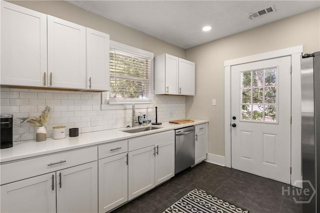 2301 Alaska St, Savannah, GA 31404 - kitchen featuring appliances with stainless steel finishes, dark tile patterned floors, healthy amount of natural light, light countertops, and recessed lighting