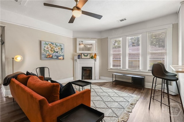 2301 Alaska St, Savannah, GA 31404 - living area featuring ceiling fan, a fireplace, and wood finished floors