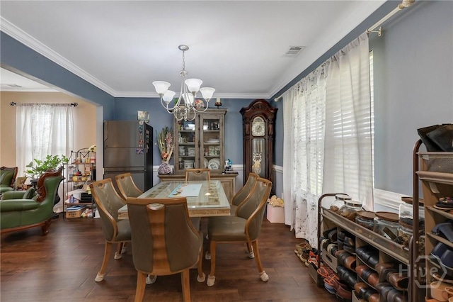 4 Broken Bit Rd, Ellabell, GA 31308 - dining room with a chandelier, dark wood-type flooring, and crown molding