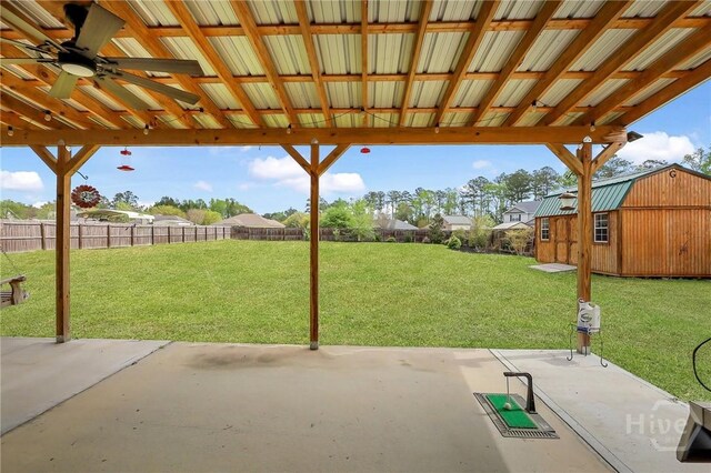 4 Broken Bit Rd, Ellabell, GA 31308 - fenced backyard featuring a patio area, ceiling fan, and an outbuilding