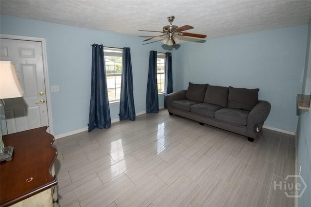 104 Ropemaker Ln, Savannah, GA 31410 - living room featuring ceiling fan, a textured ceiling, and baseboards