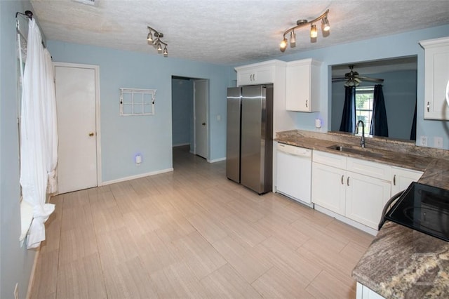 104 Ropemaker Ln, Savannah, GA 31410 - kitchen featuring freestanding refrigerator, dishwasher, a sink, white cabinetry, and a textured ceiling
