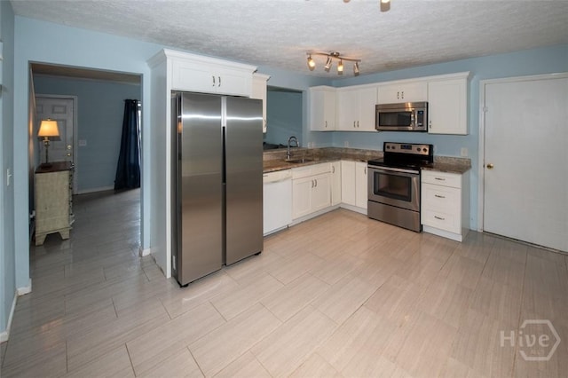 104 Ropemaker Ln, Savannah, GA 31410 - kitchen featuring stainless steel appliances, white cabinets, a textured ceiling, and a sink