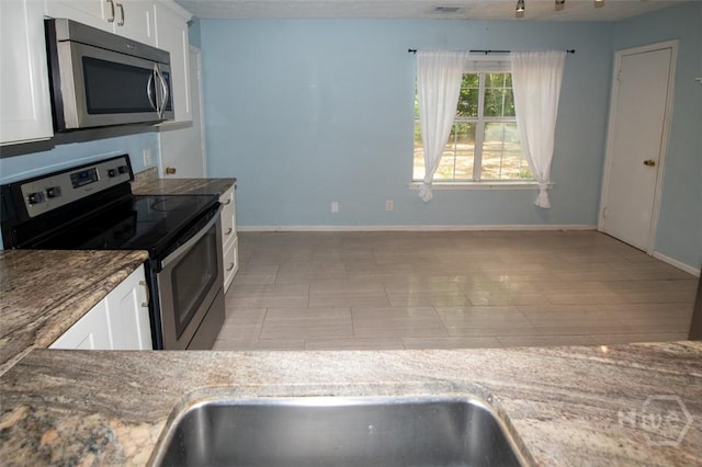 104 Ropemaker Ln, Savannah, GA 31410 - kitchen with stainless steel appliances, white cabinetry, baseboards, and stone counters