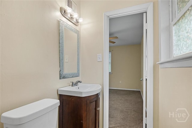 8519 Cresthill Ave, Savannah, GA 31406 - bathroom with vanity, toilet, healthy amount of natural light, and a ceiling fan