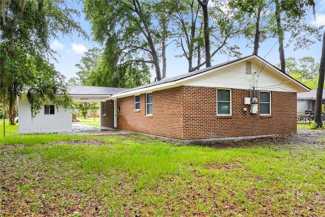 8519 Cresthill Ave, Savannah, GA 31406 - view of side of home with a yard, a carport, and brick siding