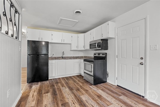 8519 Cresthill Ave, Savannah, GA 31406 - kitchen featuring stainless steel appliances, white cabinets, dark wood finished floors, and a sink