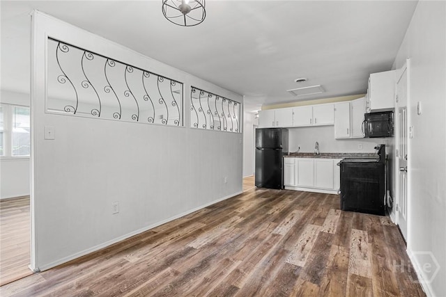 8519 Cresthill Ave, Savannah, GA 31406 - kitchen featuring black appliances, dark wood-type flooring, white cabinetry, and baseboards