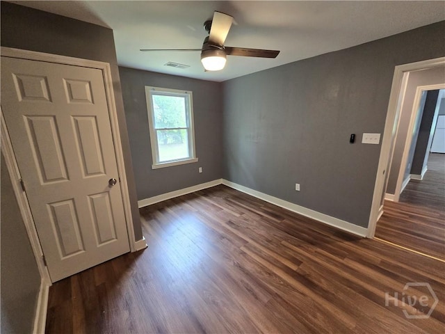 1922 Fenwick Ave, Savannah, GA 31405 - unfurnished bedroom featuring baseboards, dark wood-type flooring, and ceiling fan