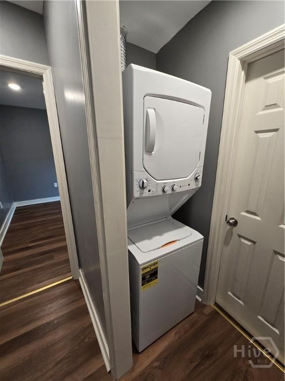 1922 Fenwick Ave, Savannah, GA 31405 - laundry area featuring stacked washer and clothes dryer, dark wood-style floors, and baseboards