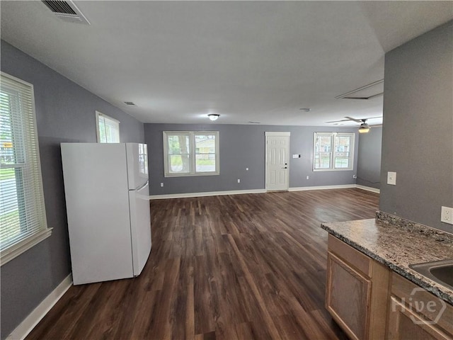 1922 Fenwick Ave, Savannah, GA 31405 - kitchen featuring freestanding refrigerator, dark wood-type flooring, and baseboards