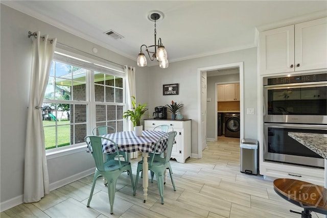 510 Braves Field Dr, Guyton, GA 31312 - dining space featuring washer / dryer, crown molding, plenty of natural light, a chandelier, and baseboards