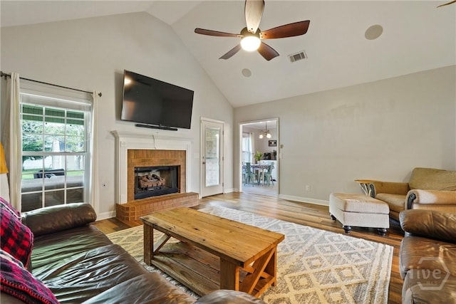 510 Braves Field Dr, Guyton, GA 31312 - living room featuring high vaulted ceiling, a ceiling fan, wood finished floors, a brick fireplace, and baseboards