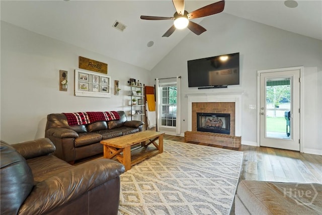 510 Braves Field Dr, Guyton, GA 31312 - living room with a ceiling fan, healthy amount of natural light, wood finished floors, a fireplace, and high vaulted ceiling