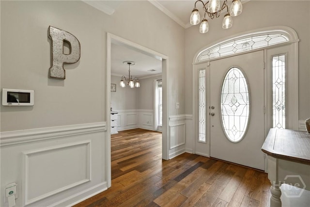 510 Braves Field Dr, Guyton, GA 31312 - foyer with a chandelier, ornamental molding, dark wood finished floors, and wainscoting