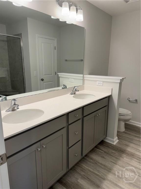 40 Hidden Pointe Dr, Savannah, GA 31419 - bathroom featuring toilet, double vanity, a stall shower, wood finished floors, and baseboards