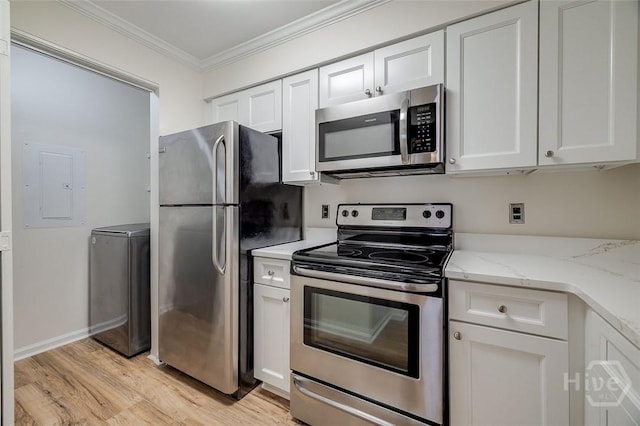 12300 Apache Ave Unit 1206, Savannah, GA 31419 - kitchen featuring appliances with stainless steel finishes, washer / dryer, ornamental molding, light wood-style floors, and electric panel