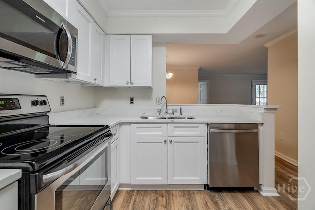 12300 Apache Ave Unit 1206, Savannah, GA 31419 - kitchen featuring appliances with stainless steel finishes, a sink, crown molding, light wood-type flooring, and white cabinetry