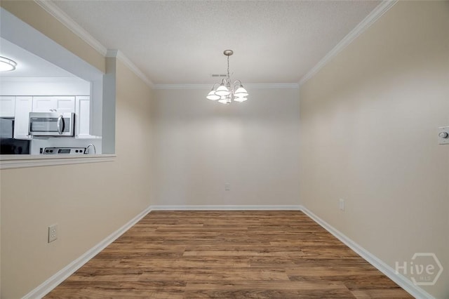 12300 Apache Ave Unit 1206, Savannah, GA 31419 - unfurnished dining area featuring ornamental molding, a chandelier, wood finished floors, and baseboards