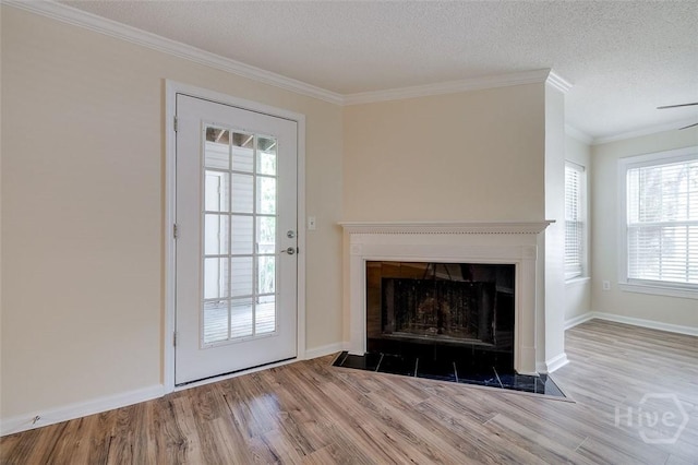 12300 Apache Ave Unit 1206, Savannah, GA 31419 - unfurnished living room featuring wood finished floors, a fireplace with flush hearth, crown molding, a textured ceiling, and baseboards