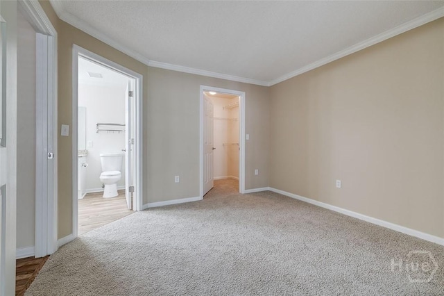 12300 Apache Ave Unit 1206, Savannah, GA 31419 - unfurnished bedroom with carpet, ornamental molding, a walk in closet, and baseboards